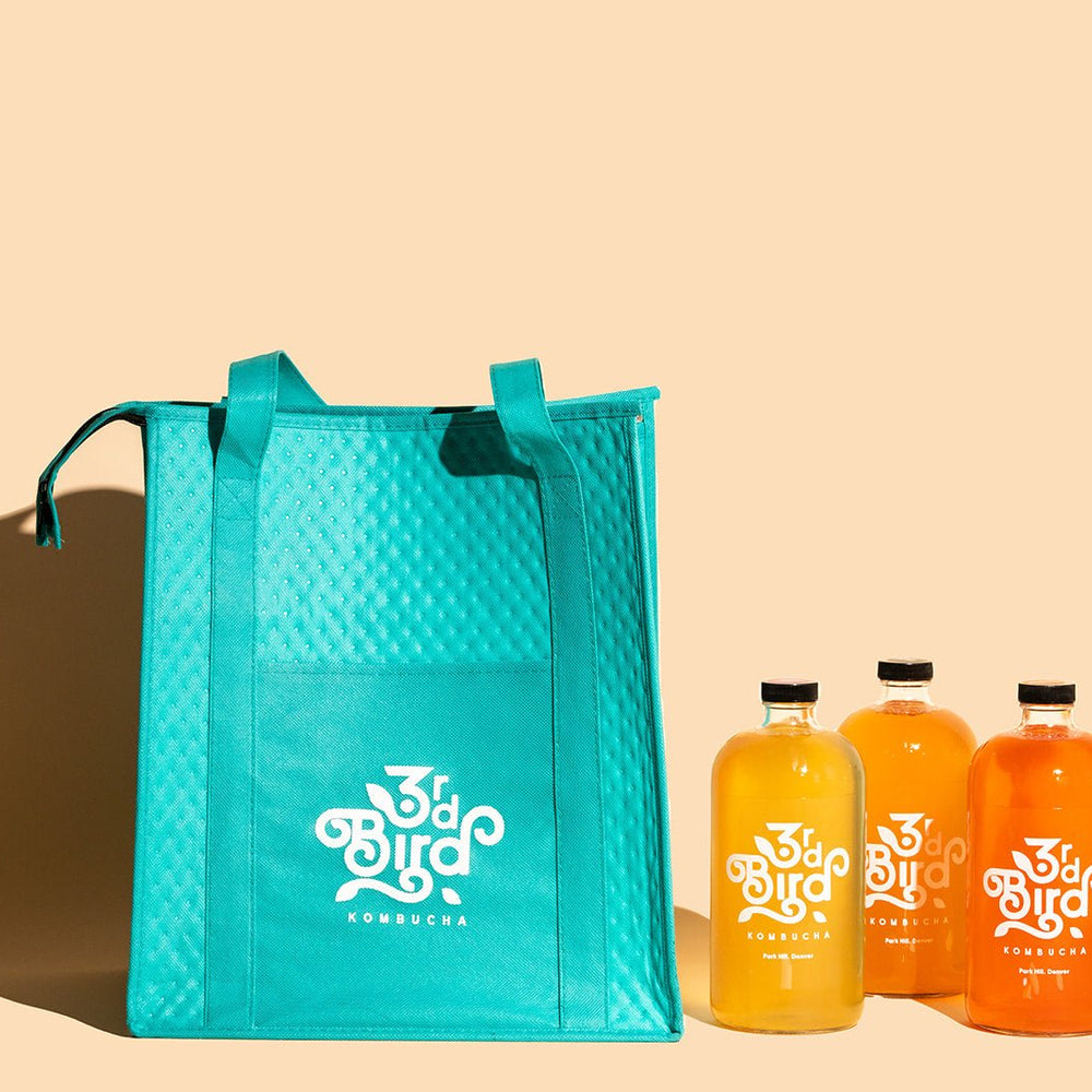 Teal insulated bag with 4 bottles of kombucha 