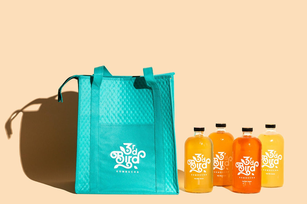 Teal insulated bag with 4 bottles of kombucha 