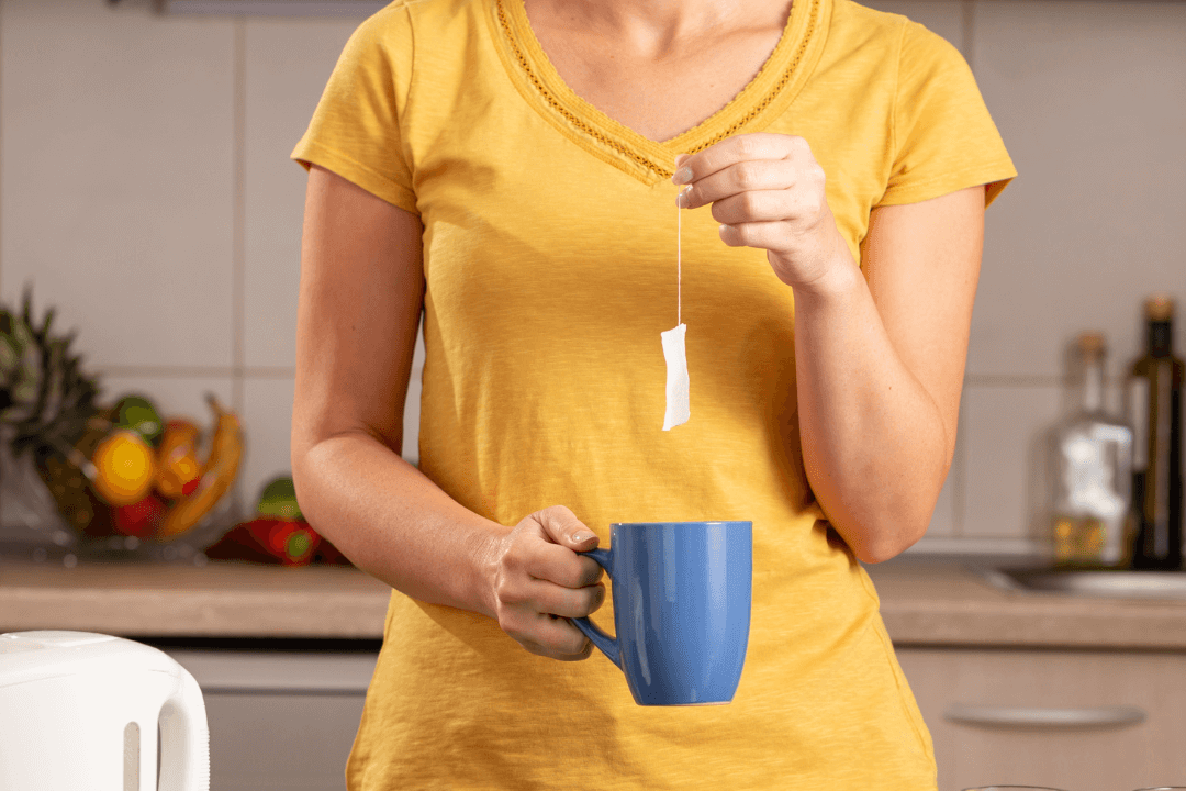 Woman's hand making hot tea